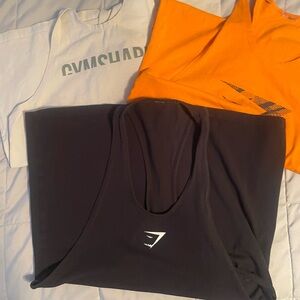 Gymshark Trio: Black, Orange, and Light Gray Tops